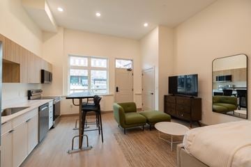 Lowell apartment for rent - A modern kitchen with a dining table and chairs.