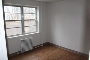 Syracuse apartment for rent - an empty room with a radiator and a large window