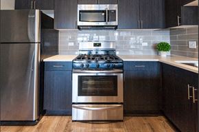 Chicago apartment for rent - a kitchen with a stainless steel stove and a microwave