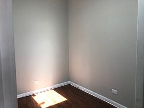 Chicago apartment for rent - the corner of a room with wood flooring and gray walls