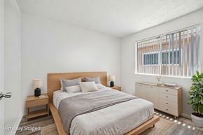 Van Nuys apartment for rent - A bedroom with a bed, nightstands, and a plant.