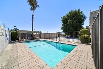 N. Hollywood apartment for rent - A small pool surrounded by a fence and a palm tree.