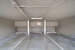 Valley Village apartment for rent - A spacious, unfinished room with concrete floors and walls, and exposed pipes on the ceiling.