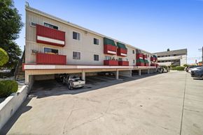 N. Hollywood apartment for rent - A large white building with red and green accents.