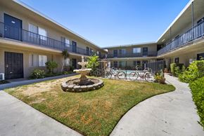 Van Nuys apartment for rent - A courtyard with a fountain and bicycles.