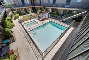 Van Nuys apartment for rent - A small pool surrounded by a metal fence.