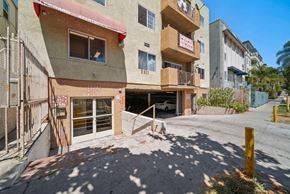 Los Angeles apartment for rent - A building with a red awning and a white car parked in the garage.