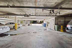 Los Angeles apartment for rent - A parking garage with a white car parked on the left side.