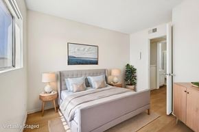 Los Angeles apartment for rent - A bedroom with a large bed and a painting on the wall.
