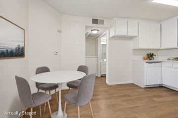 Los Angeles apartment for rent - A white dining table with grey chairs in a white kitchen.