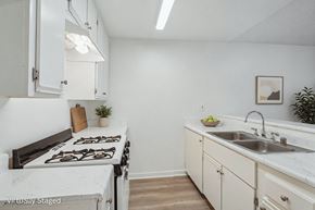 North Hills apartment for rent - A kitchen with a stove top oven, a sink and plenty of storage