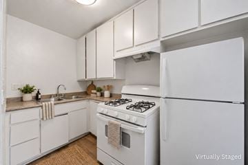 Van Nuys apartment for rent - A white kitchen with a stove and refrigerator.