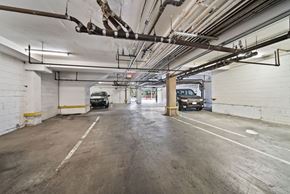 Los Angeles apartment for rent - A parking garage with a concrete floor and white walls.