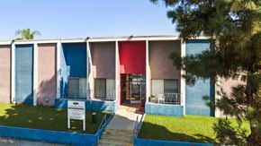 North Hills apartment for rent - A building with a blue, pink and red exterior.