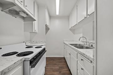 Los Angeles apartment for rent - A kitchen with white appliances and cabinets.