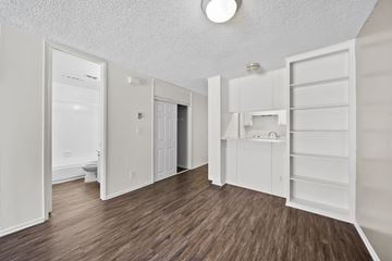 Los Angeles apartment for rent - A white kitchen with wood flooring and a white ceiling.