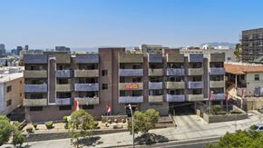 Los Angeles apartment for rent - A large apartment complex with a red sign in front.
