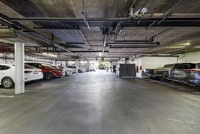 Los Angeles apartment for rent - A spacious parking garage with multiple cars parked.