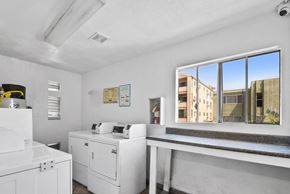 Los Angeles apartment for rent - A white room with a large window showing a view of a building outside.