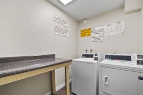 Los Angeles apartment for rent - A laundry room with washers and dryers and a counter.