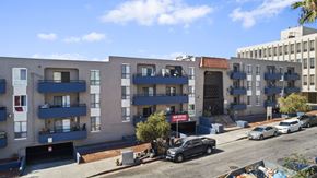 Los Angeles apartment for rent - A street view of a residential area with cars parked on the side of the road.
