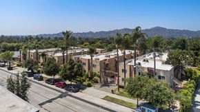 Pasadena apartment for rent - A street view of a residential area with cars parked on the side of the road.
