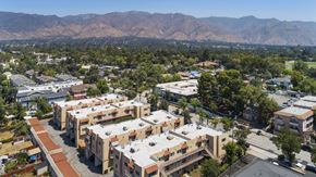 Pasadena apartment for rent - A view of a residential area with apartment buildings and a mountain range in the background.
