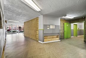Los Angeles apartment for rent - A long hallway with a green door at the end.