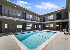 Hawthorne apartment for rent - A large indoor swimming pool in a building with balconies.