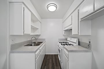 Hawthorne apartment for rent - A small white kitchen with a sink and stove.