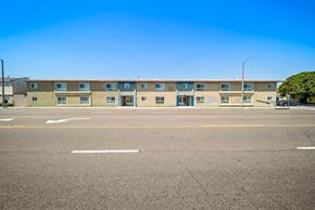 Hawthorne apartment for rent - A row of apartment buildings with a clear blue sky above.