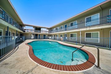 Hawthorne apartment for rent - A swimming pool in a courtyard surrounded by apartment buildings.