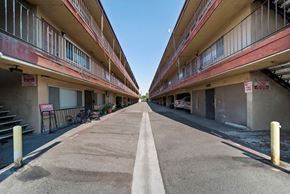 Pico Rivera apartment for rent - A long, narrow road separates two rows of apartment buildings.