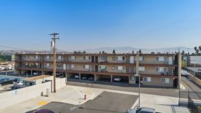 Pico Rivera apartment for rent - A parking lot in front of a multi-story apartment building.