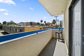 Los Angeles apartment for rent - A balcony with a chair and a view of the city.