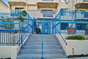Los Angeles apartment for rent - A blue gate leads to a building entrance.