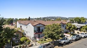 Los Angeles apartment for rent - A sunny day in a residential area with houses and parked cars.
