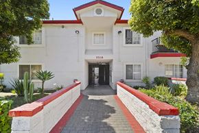 Los Angeles apartment for rent - A white building with a red roof and a black awning with the number 5708 on it.