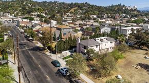 Los Angeles apartment for rent - A street view of a residential area with houses and parked cars.