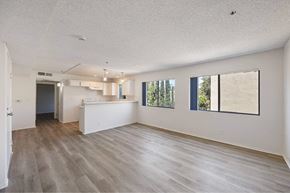 Los Angeles apartment for rent - A spacious room with wooden flooring and a large window.