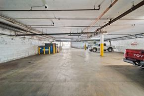 Los Angeles apartment for rent - A Toyota truck is parked in a large, empty parking garage.