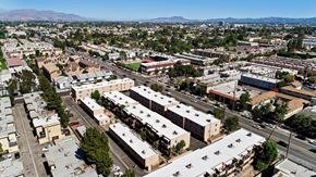 North Hills apartment for rent - A large, modern building complex is surrounded by other buildings and trees.