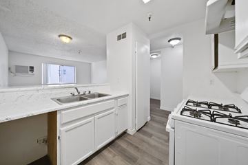 North Hills apartment for rent - A kitchen with a white counter top and a white stove top oven.