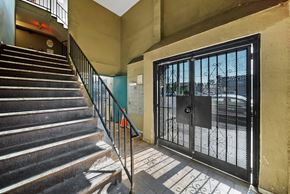 North Hills apartment for rent - A staircase with a metal railing leads to a black gate.