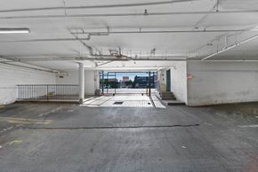North Hills apartment for rent - A large, empty parking garage with a view of the outside through a window.