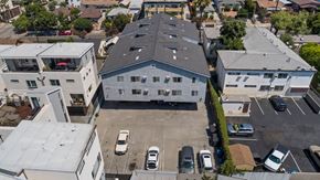 Los Angeles apartment for rent - A parking lot with cars and a building in the background.