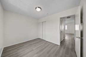 Los Angeles apartment for rent - A spacious room with wood flooring and white walls.