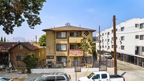 Los Angeles apartment for rent - A yellow building with a sign that says "No New Listing" is in the foreground.