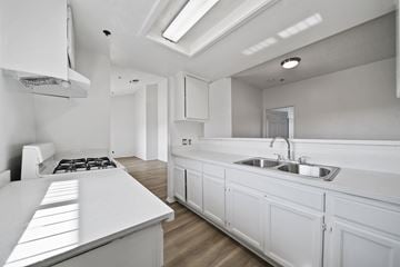 Los Angeles apartment for rent - A white kitchen with a stove top oven and a sink.