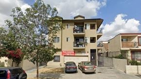 Los Angeles apartment for rent - A building with a sign that says "Now Leasing" is shown.